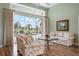 Bright living room with wood floors, ceiling fan, and large sliding glass doors overlooking the pool at 467 Sherbrooke Ct, Venice, FL 34293