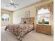 Comfortable primary bedroom with carpeting, a ceiling fan, and an ensuite bath at 467 Sherbrooke Ct, Venice, FL 34293