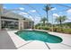 Enclosed pool with view of golf course, palm trees and an expansive lawn at 467 Sherbrooke Ct, Venice, FL 34293