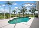 Screened-in pool offers views of the golf course and tropical landscaping at 467 Sherbrooke Ct, Venice, FL 34293