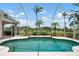 Screened-in pool surrounded by lush landscaping offering serene views of the surrounding community at 467 Sherbrooke Ct, Venice, FL 34293