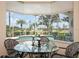 Beautiful sunroom featuring a glass table with a view of the pool and backyard at 467 Sherbrooke Ct, Venice, FL 34293