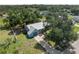 Beautiful aerial view of a charming home with a metal roof, nestled among lush trees in a neighborhood at 4688 Maraldo Ave, North Port, FL 34287