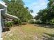 Large backyard shaded by mature trees providing privacy at 4688 Maraldo Ave, North Port, FL 34287