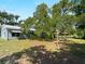 Spacious backyard with mature trees and a metal roof home, perfect for outdoor entertaining at 4688 Maraldo Ave, North Port, FL 34287