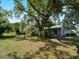 Expansive backyard with mature trees and a well-maintained house, creating a serene outdoor retreat at 4688 Maraldo Ave, North Port, FL 34287