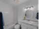 Bathroom featuring modern fixtures including a tub, toilet, and a marble top sink at 4688 Maraldo Ave, North Port, FL 34287