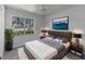 Comfortable bedroom featuring a large window and a decorative print on the wall at 4688 Maraldo Ave, North Port, FL 34287