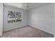 Well-lit bedroom featuring neutral carpeting and a large window overlooking greenery at 4688 Maraldo Ave, North Port, FL 34287