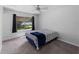 Carpeted bedroom with a window overlooking the backyard and dark curtains at 4688 Maraldo Ave, North Port, FL 34287