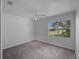 Bright bedroom featuring neutral carpeting and a large window overlooking greenery at 4688 Maraldo Ave, North Port, FL 34287