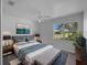 Comfortable bedroom featuring a large window and a decorative print on the wall at 4688 Maraldo Ave, North Port, FL 34287