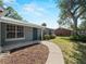 Charming home with a curved sidewalk, metal roof, and well-maintained lawn for curb appeal at 4688 Maraldo Ave, North Port, FL 34287