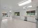 Open-concept kitchen with stainless steel dishwasher and sink with a view of the yard at 4688 Maraldo Ave, North Port, FL 34287