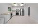 Bright kitchen featuring stainless steel appliances, white cabinetry, and tile flooring at 4688 Maraldo Ave, North Port, FL 34287