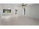 Spacious living area with white tile flooring, ceiling fans, and natural light at 4688 Maraldo Ave, North Port, FL 34287