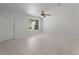 Bright living room featuring white tile floors and a large window at 4688 Maraldo Ave, North Port, FL 34287