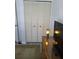 Bedroom closet with louvered doors adds storage with a woven dresser and accent lamp at 482 Pendleton Pl, Venice, FL 34292