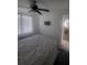 Bedroom features a ceiling fan, mounted TV, and access to the ensuite bathroom at 482 Pendleton Pl, Venice, FL 34292