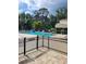 Gated community pool surrounded by lush landscaping and mature trees at 482 Pendleton Pl, Venice, FL 34292