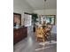 Bright dining area featuring hardwood floors, a stylish mirror, and a classic wooden table at 482 Pendleton Pl, Venice, FL 34292