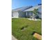 Inviting home with manicured lawn, accent lighting, and charming landscaping with a small palm tree at 482 Pendleton Pl, Venice, FL 34292