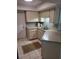 Kitchen features a corner sink with ample counter space and classic cabinetry at 482 Pendleton Pl, Venice, FL 34292