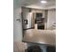 Kitchen with stainless steel refrigerator and appliances, countertop, and tiled flooring at 482 Pendleton Pl, Venice, FL 34292