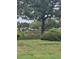 Picturesque view of a pond with lush greenery and a person stands in the background at 482 Pendleton Pl, Venice, FL 34292