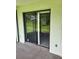 A sliding glass door to a screened in patio area offers seamless access to outdoor living at 482 Pendleton Pl, Venice, FL 34292