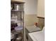 The laundry room features a utility sink and chrome shelving, providing practicality and storage solutions at 482 Pendleton Pl, Venice, FL 34292