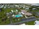 An aerial view shows the community pool, shuffleboard courts, parking, and building exteriors at 527 Walnut Cir, Venice, FL 34285