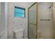 Bathroom featuring a toilet, shower with glass door, and a window at 527 Walnut Cir, Venice, FL 34285