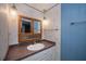 Bathroom showcasing a vanity, mirror, decorative lighting, and floral wallpaper at 527 Walnut Cir, Venice, FL 34285