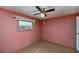 Bedroom with window, ceiling fan, neutral carpet providing a comfortable space at 527 Walnut Cir, Venice, FL 34285