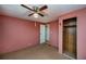 Bedroom showing closet space, doorway, neutral carpet and ceiling fan at 527 Walnut Cir, Venice, FL 34285