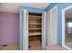 Bedroom closet featuring wood shelving, ample space, and paneled doors at 527 Walnut Cir, Venice, FL 34285