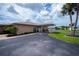 Shot of clubhouse featuring covered drive and well-manicured landscaping at 527 Walnut Cir, Venice, FL 34285