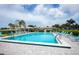 Enjoy a relaxing dip in the community pool with plenty of seating and a tropical atmosphere at 527 Walnut Cir, Venice, FL 34285