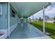 Spacious covered patio providing ample outdoor living space, featuring durable flooring and convenient access at 527 Walnut Cir, Venice, FL 34285