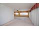 Open living room area with carpet, ceiling fan, and natural light from large windows at 527 Walnut Cir, Venice, FL 34285
