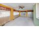 Living room featuring carpet, ceiling fan, and lots of natural light at 527 Walnut Cir, Venice, FL 34285