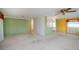 Spacious living room featuring carpet flooring, ceiling fan and view to the kitchen at 527 Walnut Cir, Venice, FL 34285