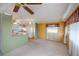 Bright living room with ceiling fan, carpet flooring, and adjacent eat-in kitchen at 527 Walnut Cir, Venice, FL 34285
