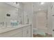 Bright bathroom with double sinks, a large mirror, and a shower-tub combo at 5459 Bentgrass Dr # 2-304, Sarasota, FL 34235