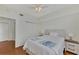 This cozy bedroom features a ceiling fan, wood floors, and plenty of closet space at 5459 Bentgrass Dr # 2-304, Sarasota, FL 34235