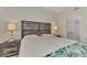Bright bedroom featuring a decorative headboard and stylish lamps at 5459 Bentgrass Dr # 2-304, Sarasota, FL 34235