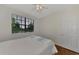 This naturally lit bedroom features a window with views of lush greenery and a calming color scheme at 5459 Bentgrass Dr # 2-304, Sarasota, FL 34235