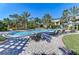 The community pool features comfortable chaise lounges under the shade of swaying palm trees at 5459 Bentgrass Dr # 2-304, Sarasota, FL 34235