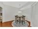 Dining room area featuring seating for four, a chandelier, and wood flooring at 5459 Bentgrass Dr # 2-304, Sarasota, FL 34235